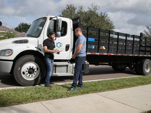 Greentech Renewables Employee Delivering Solar Panels